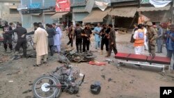 Pakistani security officials examine the site of a deadly bomb blast in Dera Ismail Khan on November 3. 