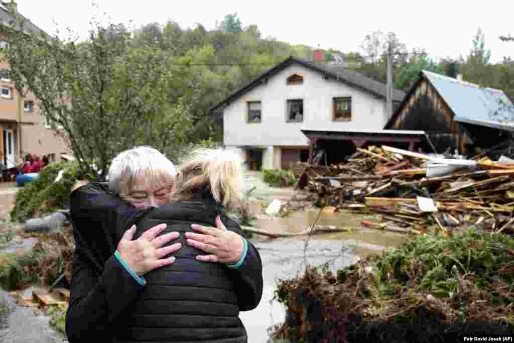 A woman embraces a relative after being evacauted from her flooded home in Jesenik, Czech Republic. 