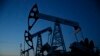 Pump jacks are seen at LUKoil's Imilorskoye oil field. Falling oil prices and revenues are endangering Russia's credit rating.