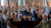 Supporters of Tehrik-e Labaik Pakistan (TLP) gather on a blocked street to protest against the arrest of their leader after he demanded the expulsion of the French ambassador over depictions of Prophet Muhammad, in Peshawar, on April 13.