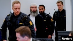 Zaniar Matapour (center) attends court in Oslo earlier this year. 