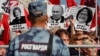 A rally against pension reform in Moscow on September 22. The placards read "Public Enemy" and show President Vladimir Putin (center), Federation Council speaker Valentina Matviyenko (left), and Central Bank Governor Elvira Nabiullina.