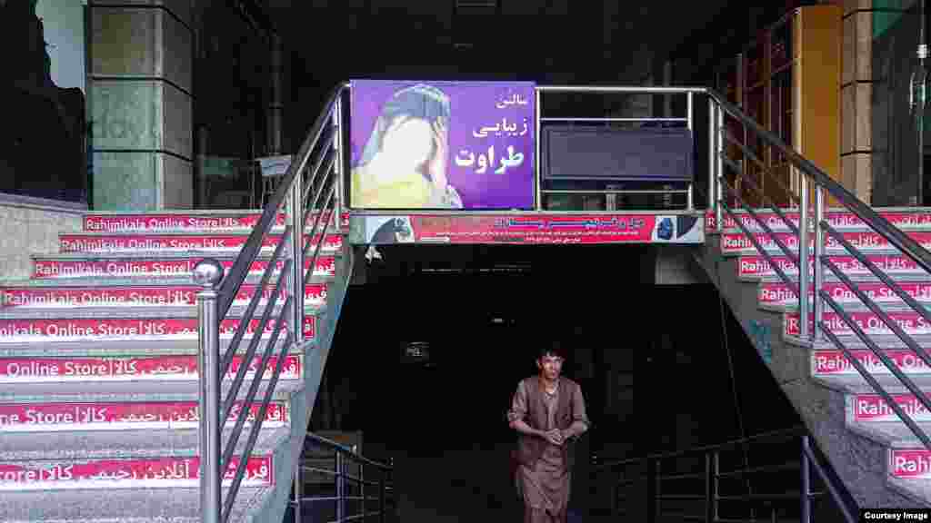 A woman’s face that was painted over at the entrance to a shopping mall 