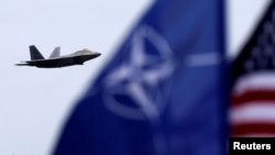 A U.S. Air Force F-22 Raptor fighter flies over the military air base in Siauliai, Lithuania.