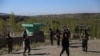 Afghan security personnel keep watch at the site of an attack by Taliban militants on a government compound in the Khwaja Omari district in the southeastern province of Ghazni on April 12.