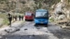 Pakistani security personnel inspect the site of a suicide attack in Khyber Pakhtunkhwa Province on March 26 that killed five Chinese engineers and a Pakistani driver.