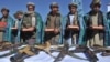 Сүрөттө: "Талибан" кыймылынын мурдагы мучөлөрү куралдарын таштап, Куранга кол коюп, ант беришүүдө