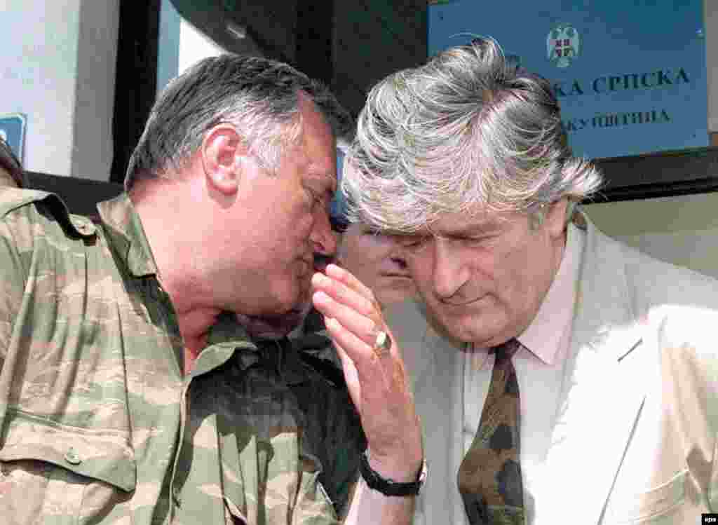 Bosnian Serb Commander Ratko Mladic speaks to Bosnian Serb leader Radovan Karadzic during a meeting in Pale, Bosnia and Herzegovina, on August 5, 1993. Both men are currently in custody and on trial for war crimes at the International Criminal Tribunal in The Hague.