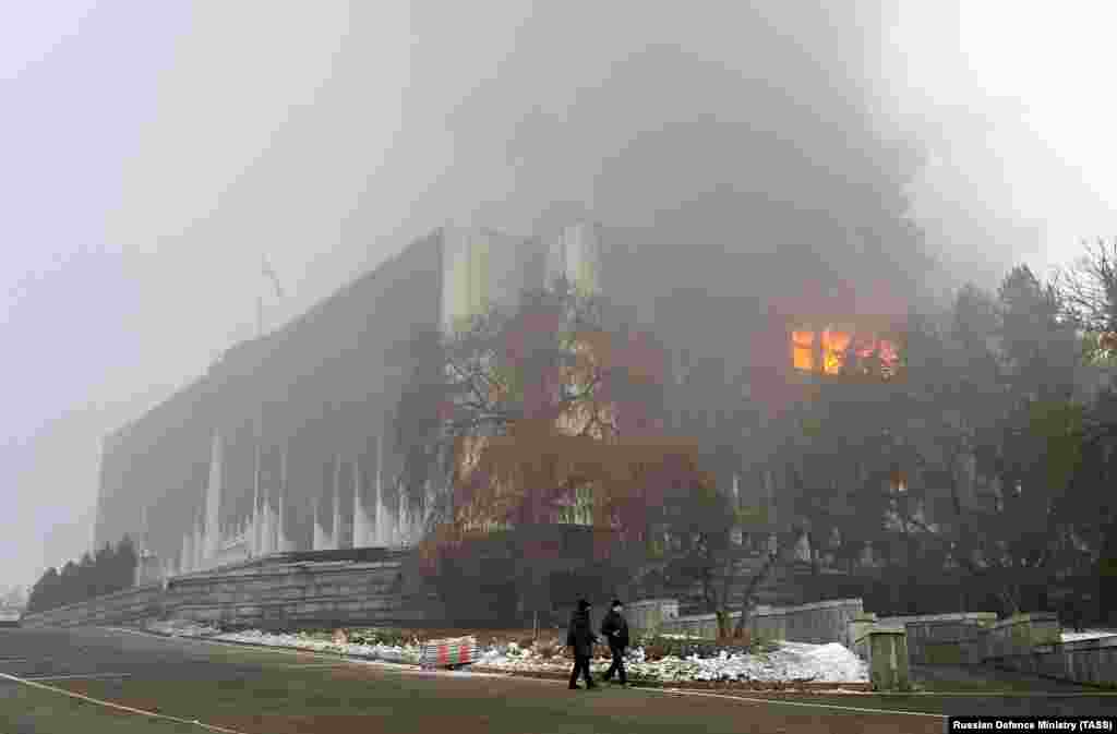 The mayor&#39;s office in central Almaty burns on January 6 after being stormed and ransacked by protesters a day earlier.