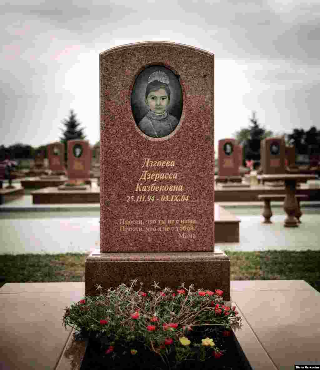 The grave of Kristina's sister, Dzera, stands with those of other Beslan victims in the cemetery that locals now call the "Little Town of Angels." The cemetery is almost never empty. For many survivors, it's become a place to seek calm and carry out symbolic rites of passage for the children who never lived to adulthood. This year, many parents adorned gravestones with graduation ribbons for children who would have finished high school in 2014. Kristina says she still goes to the cemetery during trips home to talk to Dzera; it makes her feel happy. Kristina's mother remains deeply scarred by the loss of her younger daughter. The inscription on Dzera's gravestone reads, "Forgive us that you're not here with us, and forgive me that I'm not there with you -- Mama."