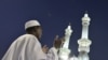 A Muslim pilgrim prays outside the Grand Mosque in Mecca, Saudi Arabia. Under King Abdullah, the kingdom has moved toward a more inclusive form of Islam.