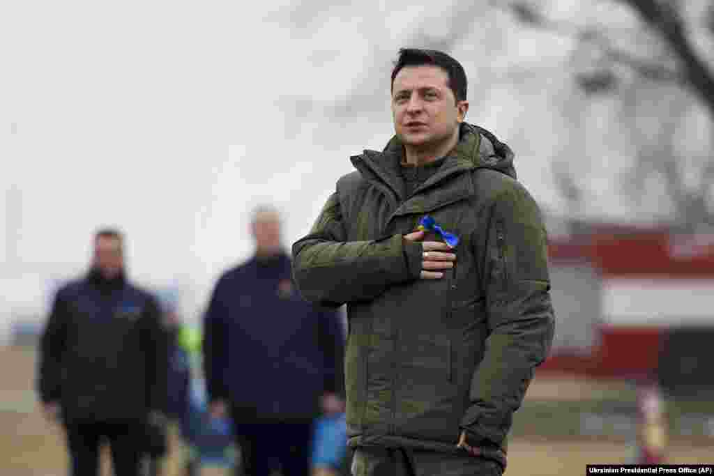 Ukrainian President Volodymyr Zelenskiy listens to the Ukrainian national anthem as he takes part in an event for the Day of the Unity outside Kyiv, prior to his trip to the Rivne and Donetsk regions. Zelenskiy encouraged Ukrainians to “hang our national flags, put on blue and yellow ribbons, and show our unity to the whole world." 