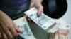 Russia -- An employee of a bank counts ruble banknotes in Moscow, September 2, 2014