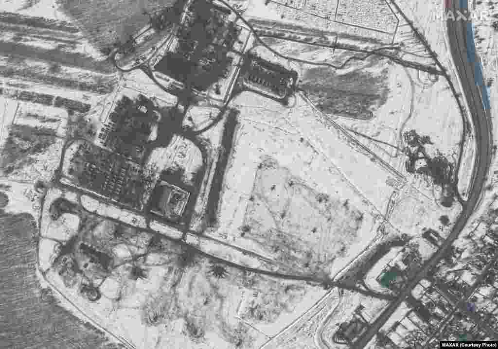 This satellite image taken on February 20 shows a helicopter deployment, a battle group, and troops in Valuyki, Russia, according to Maxar. Some equipment has been deployed in a field approximately 15 kilometers north of the Ukrainian border. 