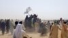 People on vehicles gather near Friendship Gate crossing on Pakistan-Afghanistan border, in Chaman