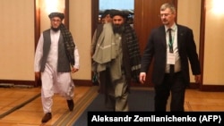 Mullah Baradar (center), the Taliban's deputy leader and chief negotiator, arrives at the March 18
Moscow conference aimed at breathing life into peace talks between the Afghan government and the Taliban.
