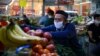 Kazakhstan - A vendor arranges fruits and vegetables at a market in Almaty on April 25, 2020, amid the coronavirus pandemic. (Photo by Ruslan PRYANIKOV / AFP)