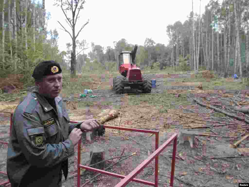 A policeman guards the site of the planned highway in late August.