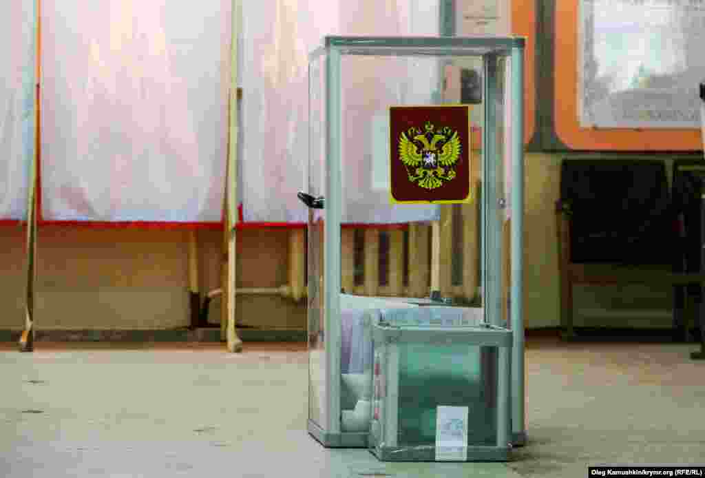 At a polling station in Simferopol, Russia's double-headed eagle has replaced the Ukrainian emblem.