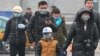 China -- People wear masks walking in the street while the PM2.5 Air Quality Index (AQI) reaches more than 500 in Beijing city, 15 January 2015. 