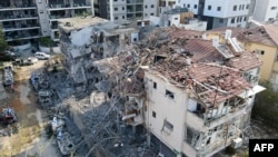 Officials say an Iranian missile damaged buildings in the Israeli city of Ramat Gan near Tel Aviv, June 14, 2025.