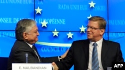 Belgium -- EU Commissioner for Enlargement Stefan Fule (R) and Armenian Foreign Minister Edward Nalbandian shake hands during a press conference at the EU Headquarters in Brussels, December 9, 2013