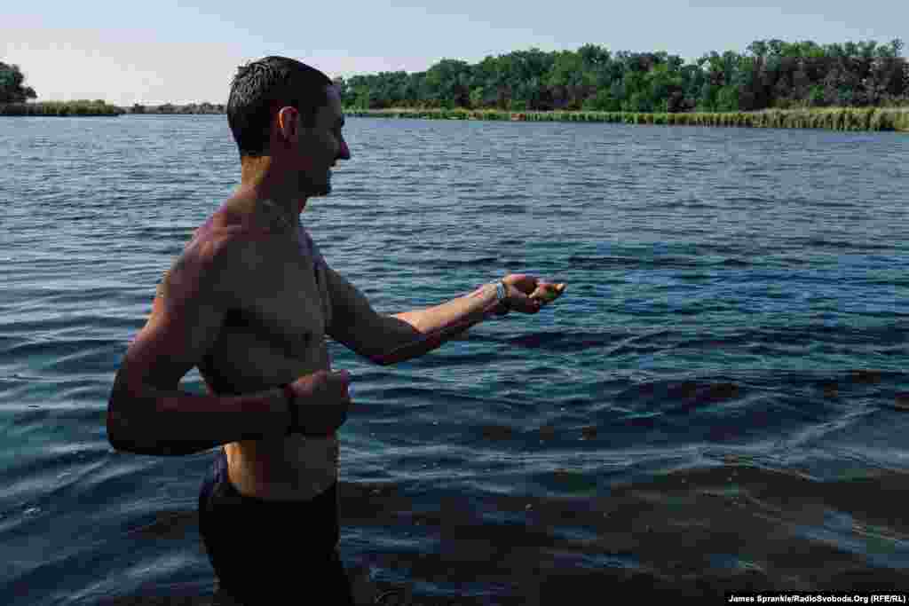 Dice pulls in a fishing line during a swimming trip outside of Pisky. 