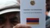 A protester holding an Armenian constitution, undated
