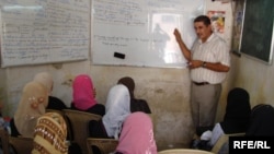 Iraqi girls attend an English class. The high rate of school drop-outs has worsened Iraq's illiteracy problem.