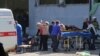 WATCH: Local media showed chaotic scenes after a blast in Kerch, Crimea, with one injured man being driven away on the back of a truck while other people held a drip he was connected to. 