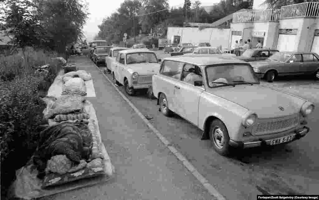 East German refugees sleep alongside their Trabant cars in Budapest. With Hungary’s dramatic shift toward freedom in 1989, thousands of East Germans enduring the constant snooping of the Stasi secret police began driving east. Hungary was one of the “fraternal socialist states" East Germans were permitted to travel to. 
