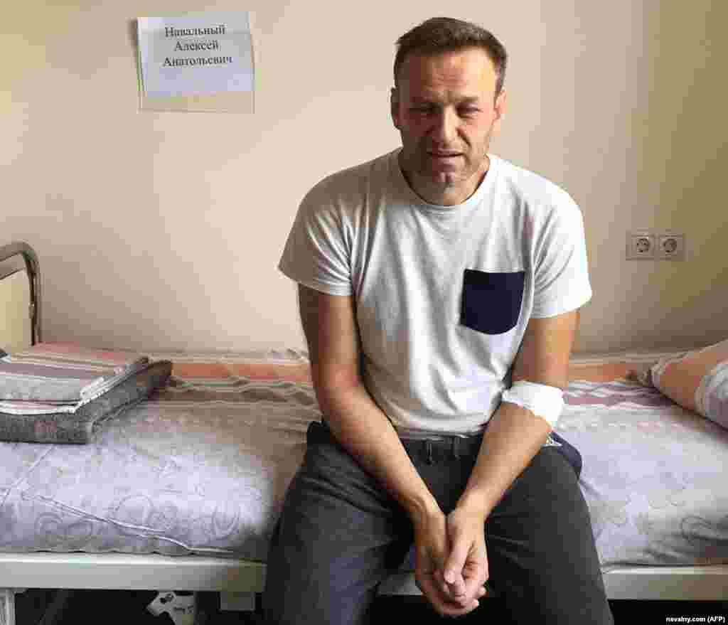 A visibly unwell Navalny, his eyes red and puffy, sits on a hospital bed in Moscow on July 29, 2019, while serving a 30-day prison term on charges of calling an unauthorized protest. He said he believed he&#39;d been poisoned, but doctors attributed his illness to an &quot;acute allergic reaction.&quot;