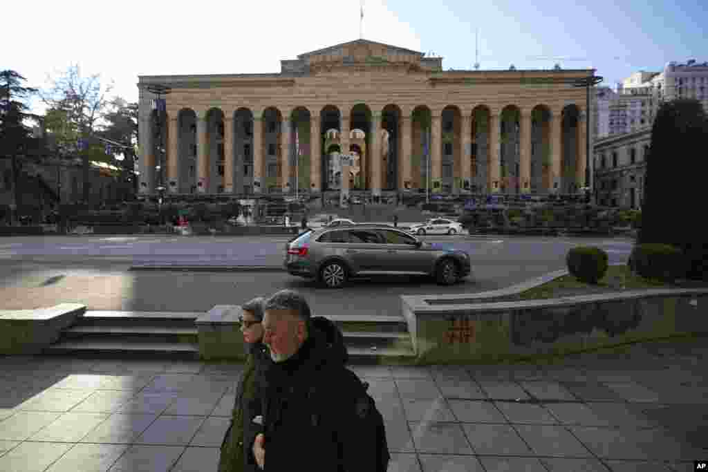 People walk along Rustaveli Avenue on December 3, 2024. Amid the current unrest, historian Chubinidze says daily efforts are being made to clean up Rustaveli Avenue. “The government is trying to hide the signs of the protests so during the day everything is working normally, even the graffiti is cleaned off." But he told RFE/RL, "from 7 p.m. the street starts to change, it becomes a battlefield.” 