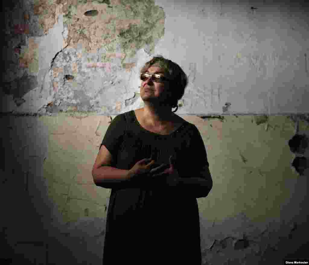 Nadezhda Guriyeva, 54, a history teacher, stands in the classroom at School No. 1 where she taught for more than 20 years. The curtains she put up with her son, Boris, still hang in the windows. Nadezhda -- or Nadya, as she prefers -- was taken hostage with her three children. Boris and her older daughter, Vera, died and their bodies burned in a fire sparked by explosives on the last day of the siege. They were 14 and 11. Boris and Vera had been scheduled to perform a dance at the school to mark the first day back. Vera's body was identified by the dress she had worn specially for the dance. Nadya and her youngest daughter escaped. Nadya now teaches in a new school built across from School No. 1. 