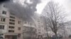 Firefighters spray water an apartment building following a Russian air attack on the Ukrainian city of Sumy on March 24.