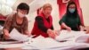 Election workers count ballots at a polling station in Bishkek.