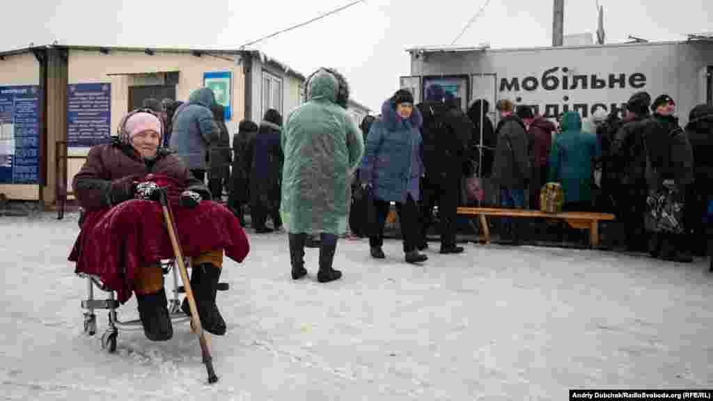 Near a checkpoint controlled by the Ukrainian military, a bank machine (right) is in regular use and is refilled with cash each day.