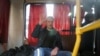 Anticorruption campaigner and opposition figure Aleksei Navalny waves as he sits inside a police van after after being detained during a rally in Moscow on March 26, 2017.