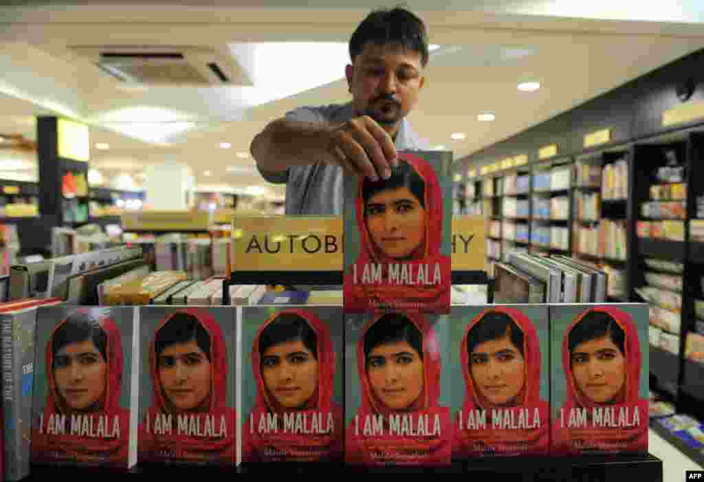 A salesman arranges copies of I Am Malala, Yousafzai's memoir co-authored with British journalist Christina Lamb, at a bookstore in Ahmedabad, India, on October 9, 2013. 