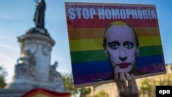 A demonstrator holds a poster depicting Russian President Vladimir Putin to denounce the antigay campaign launched in the Russian region of Chechnya during a protest in Paris last month.