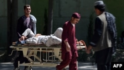 A wounded Afghan civilian receives treatment following a Taliban bomb attack in 2015. 