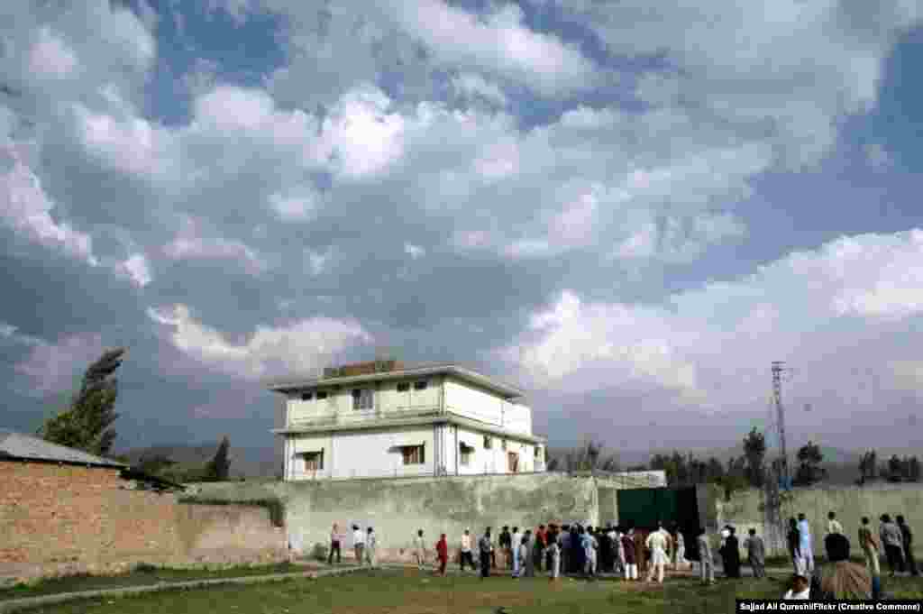 Locals gather around bin Laden’s compound on May 4, 2011. The location of the compound, a short walk from a Pakistani military base, raised suspicion that the military had known about bin Laden’s whereabouts. 
