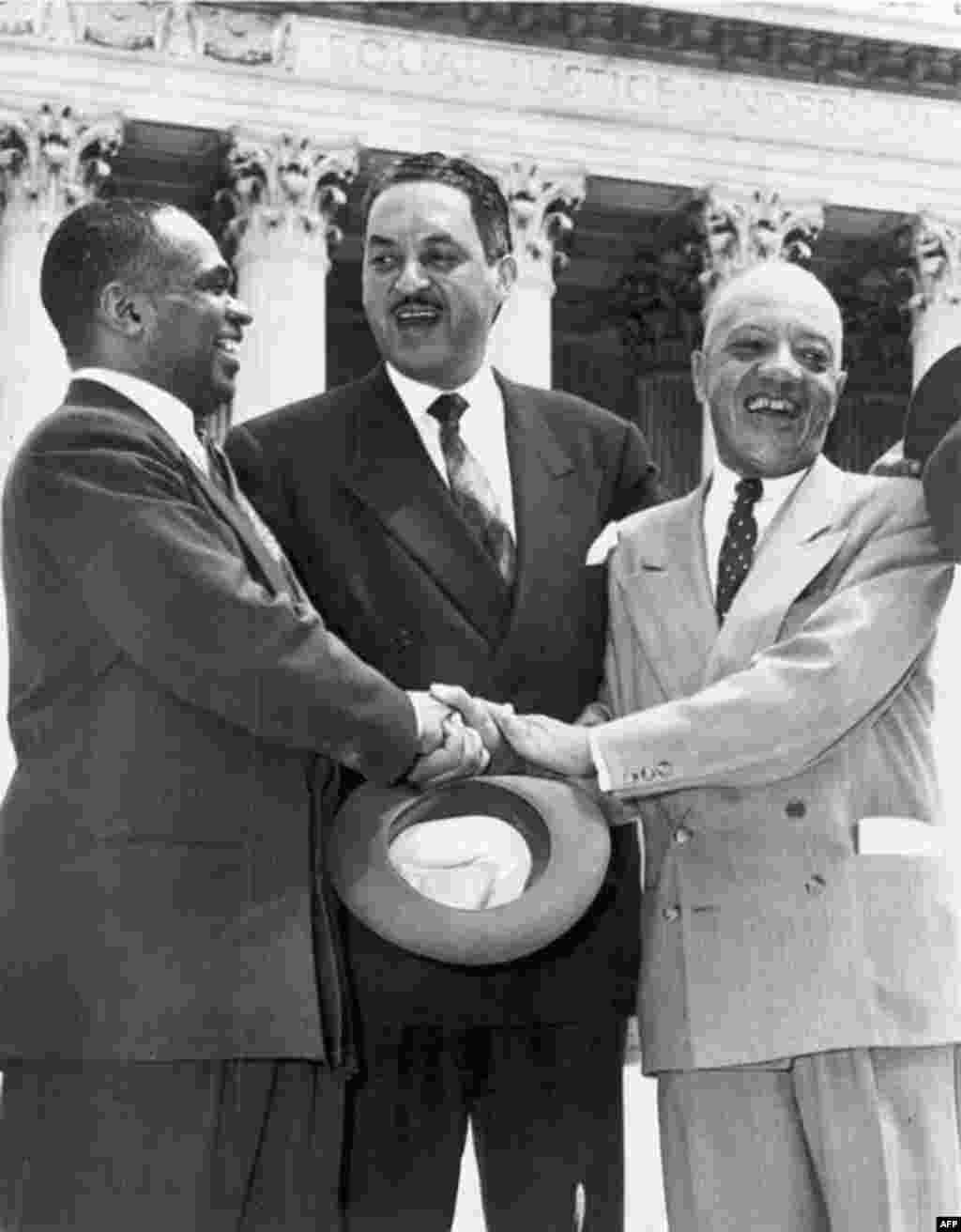 Lawyers Thurgood Marshall (center), George E.C. Hayes (left), and James Nabrit celebrate the Supreme Court's decision in Brown v. Board of Education on May 17, 1954. The ruling declared racial segregation in schools to be unconstitutional. In 1967, Thurgood Marshall became the first African-American to be appointed to the Supreme Court.