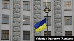 A Ukrainian flag flies in front of a government building in central Kyiv (file photo)