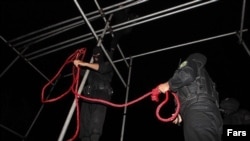 Iranian security officers prepare a rope for hanging. members preparing hanging rope. The Islamic republic has executed more people than any other country in the world other than China so far this year, according to Amnesty International. (file photo)