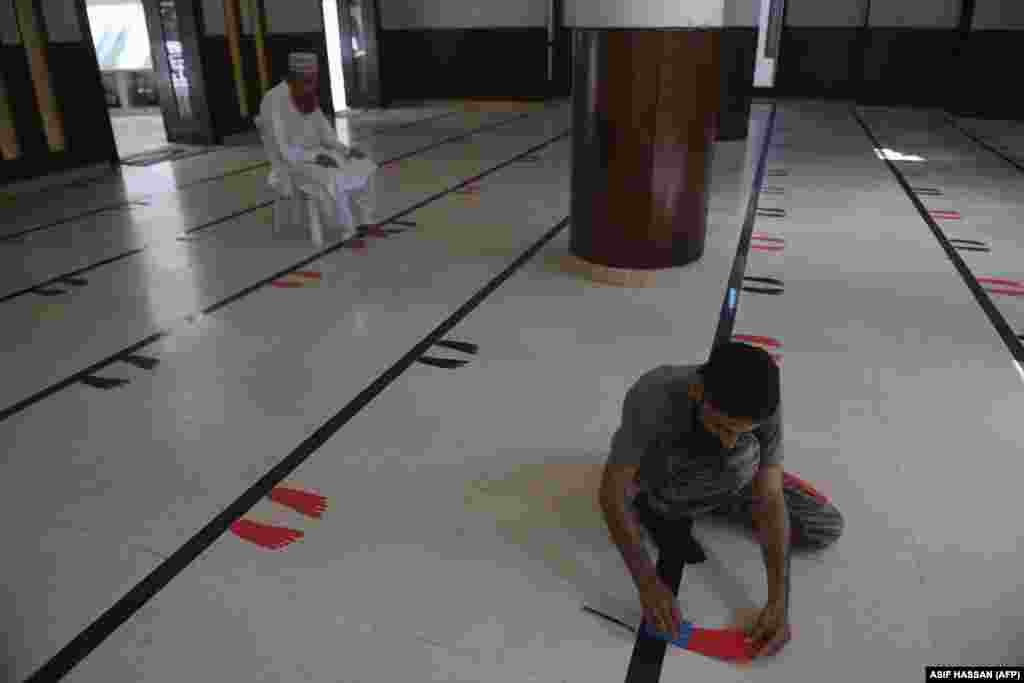 Stickers of foot silhouettes are laid on the floor of a mosque in Karachi, Pakistan, to maintain physical distancing ahead the holy month of Ramadan on April 23.