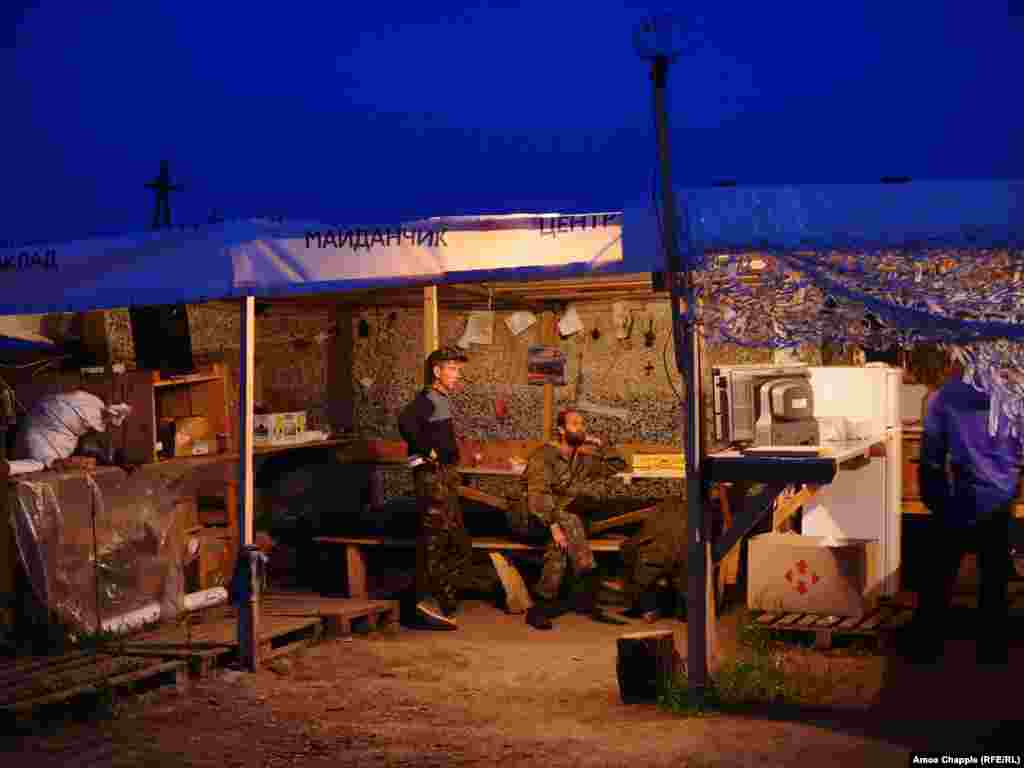 Blockaders watching television. The activists tap into electrical mains running past their camp but claim to pay for the power they use. 