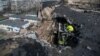 A Ukrainian firefighter works at a site an apartment building hit by a Russian drone strike, in Kyiv on March 23.