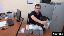 A screen-grab of Vachagan Ghazarian, a former bodyguard of Armenian ex-Prime Minister Serzh Sarkisian who was arrested after being stopped exiting a Yerevan bank on June 25 with more than $1 million in cash. 
