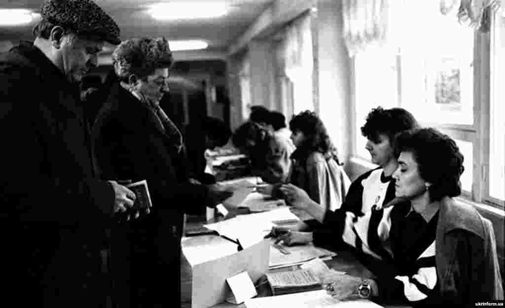Voters in Odesa sign in to receive their ballots.